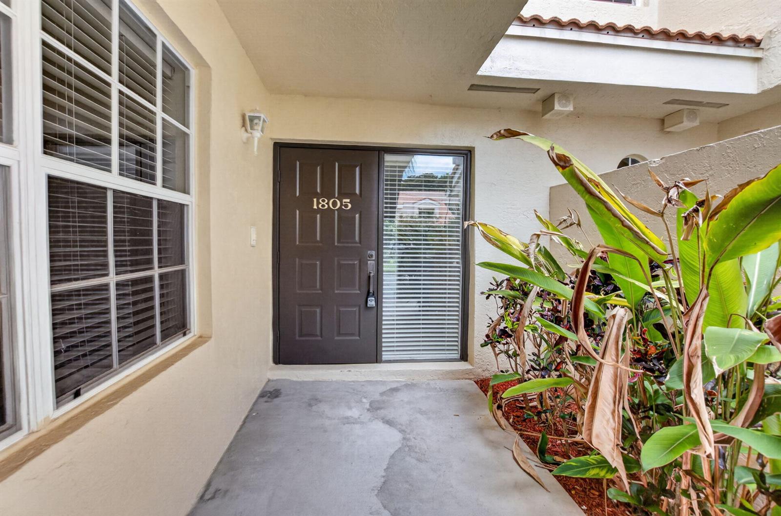 A front entryway features a brown door with the number 1805 and adjacent tropical plants — 17276 Boca Club Boulevard # 1805, Boca Raton FL 33487, BOCA RATON, FL