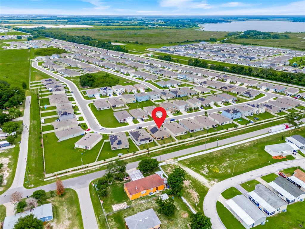 An aerial view shows a residential neighborhood with a red pin marking a specific house — 3041 TOBAGO DRIVE, HAINES CITY, FL