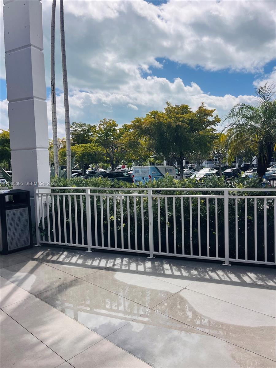 An empty room with beige carpeting and floor-to-ceiling windows overlooking a sunny outdoor area — 260 Crandon Blvd # C41, Key Biscayne FL 33149, KEY BISCAYNE, FL