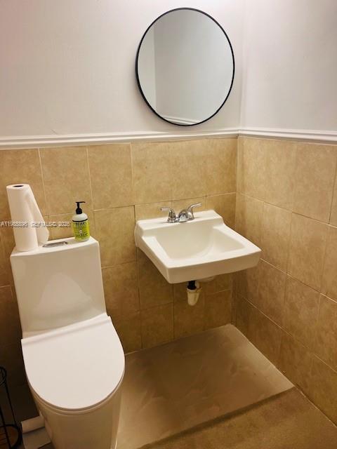 A straight wooden staircase with a white handrail leads to a closed door — 260 Crandon Blvd # C41, Key Biscayne FL 33149, KEY BISCAYNE, FL