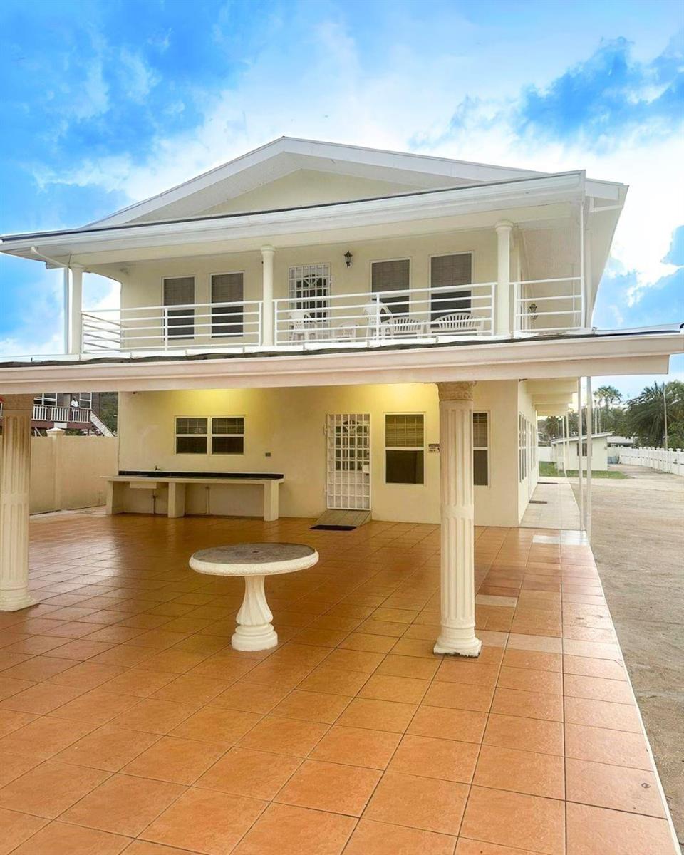 A two-story house with a tiled patio, white columns, and a balcony — LP 53 Lp 53 Gould Street, FL