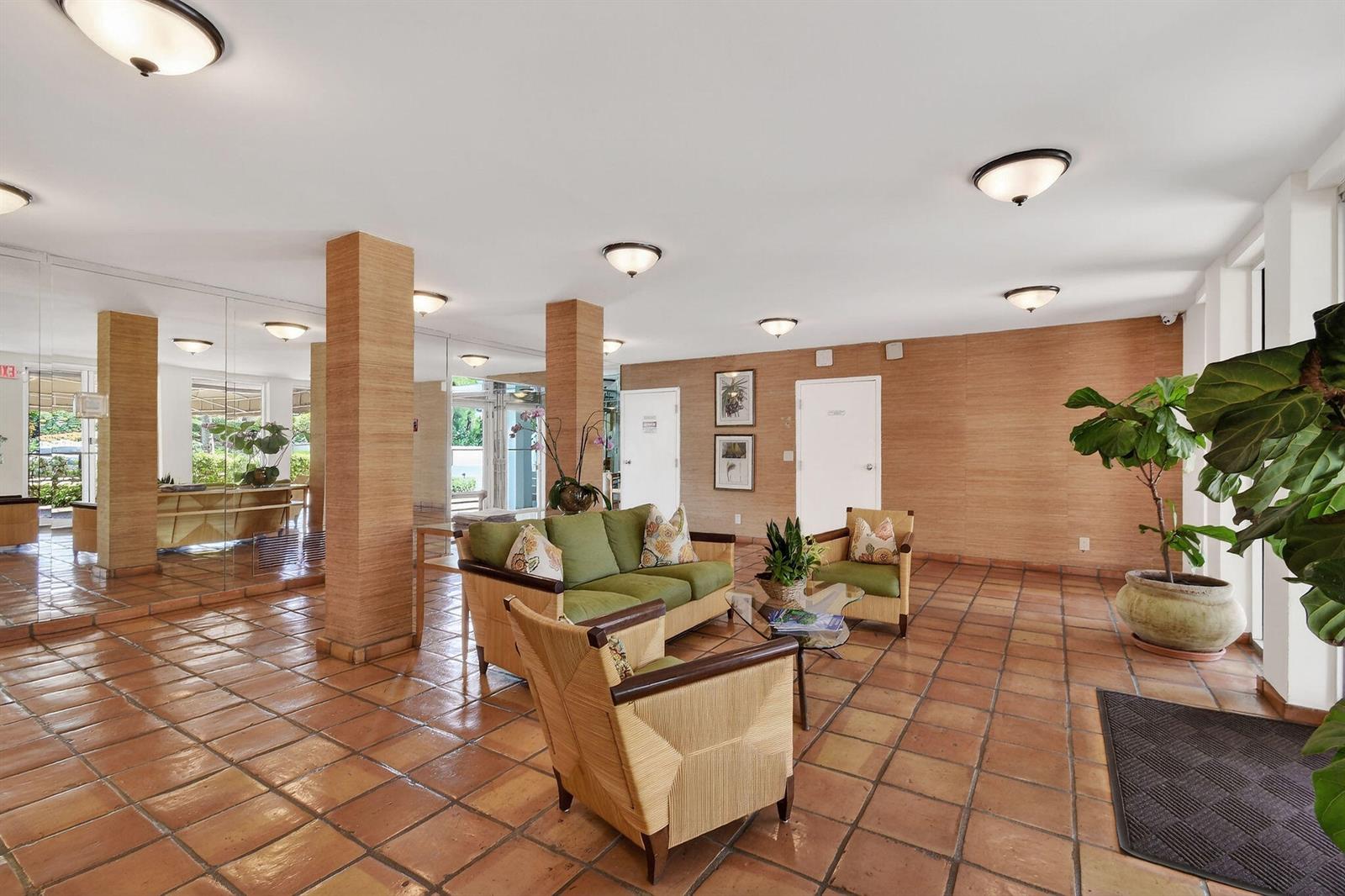 A lobby features terracotta tile floors, textured wall coverings, and a green seating area — 139 Sunrise Avenue # 2030, Palm Beach FL 33480, PALM BEACH, FL