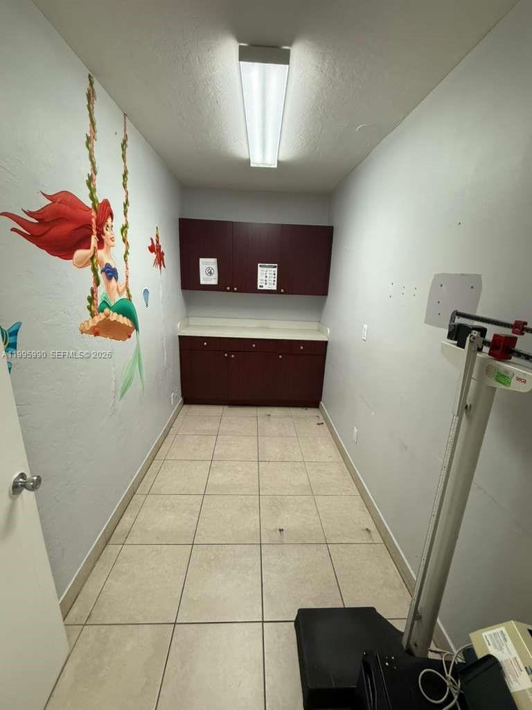 A small medical exam room features a wall mural of a mermaid and a scale — 4141 SW 6th St, Miami FL 33134, MIAMI, FL