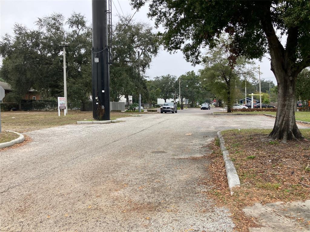 A paved parking lot sits in front of a vacant lot with a tall utility pole — 3900 N MARGUERITE AVENUE, TAMPA, FL