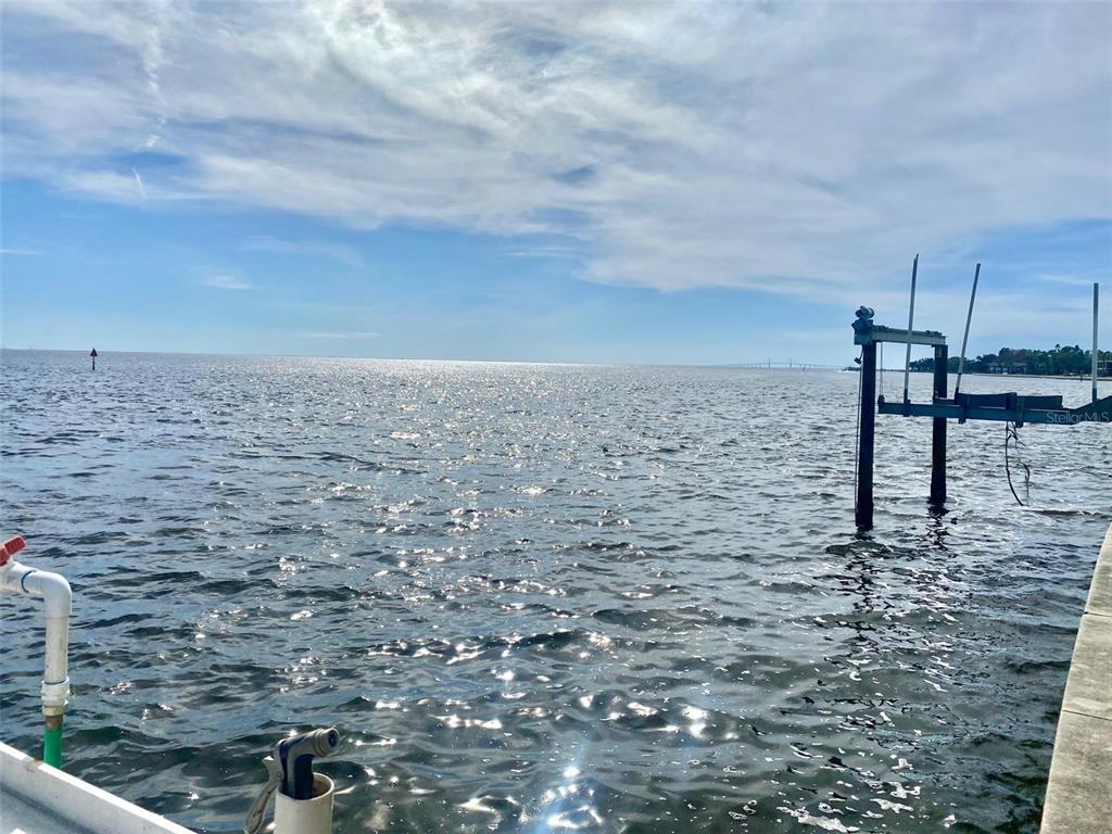 A view of a body of water with a boat lift and a distant bridge — 0 NE BEACH DRIVE SE UNIT 95SS, ST PETERSBURG, FL