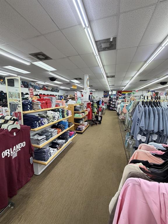 A retail store interior features rows of clothing racks and shelves filled with apparel — 6119 W IRLO BRONSON MEMORIAL HIGHWAY, KISSIMMEE, FL