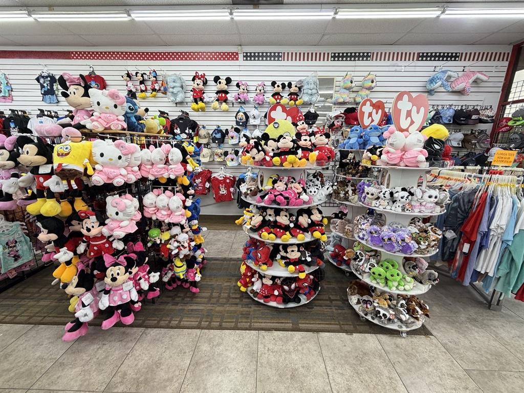 A retail store interior features shelves and circular displays stocked with various plush toys — 6119 W IRLO BRONSON MEMORIAL HIGHWAY, KISSIMMEE, FL