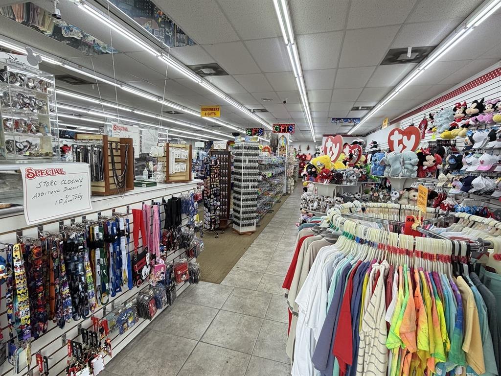 An interior view of a retail store featuring racks of clothing, plush toys, and gift items — 6119 W IRLO BRONSON MEMORIAL HIGHWAY, KISSIMMEE, FL