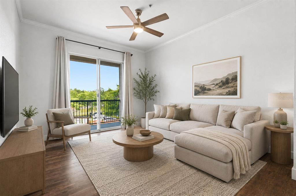 A living room features a beige sectional sofa, a round coffee table, and a balcony door — 18106 PEREGRINES PERCH PLACE UNIT 5302, LUTZ, FL