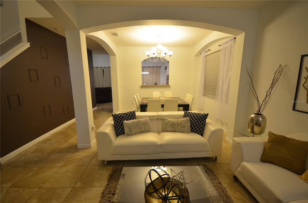 A two-story stucco house with a tile roof and a two-car garage — 2632 TRANQUILITY WAY, KISSIMMEE, FL