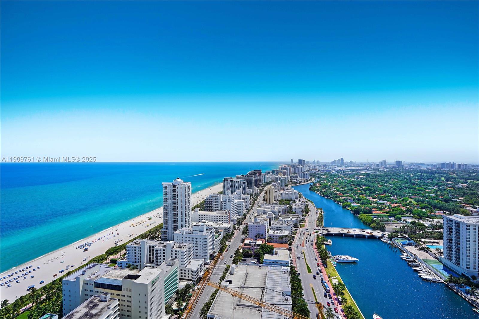 An aerial view shows a coastal city with a beach, a waterway, and high-rise buildings — 4401 Collins Ave, Miami Beach FL 33140, MIAMI BEACH, FL