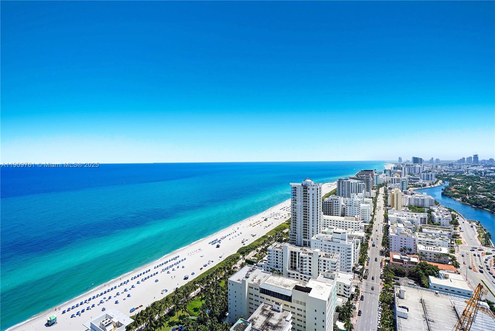 An aerial view shows a sandy beach along the ocean next to a coastal city — 4401 Collins Ave, Miami Beach FL 33140, MIAMI BEACH, FL