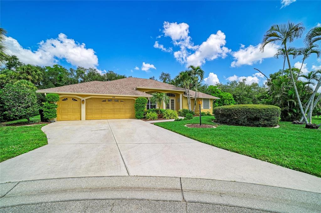 An aerial view of a single-story house with a tan roof and a concrete driveway — 6401 KYLIE CREEK WAY, SARASOTA, FL