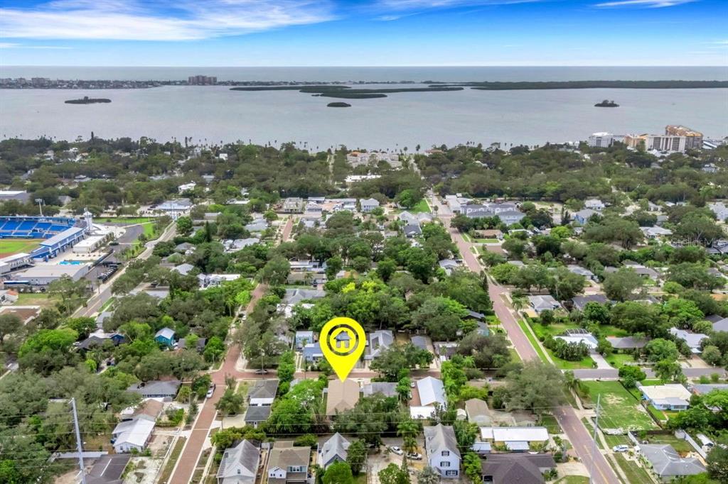 An aerial view shows a residential neighborhood near a large body of water — 439 LOUDEN AVENUE, DUNEDIN, FL