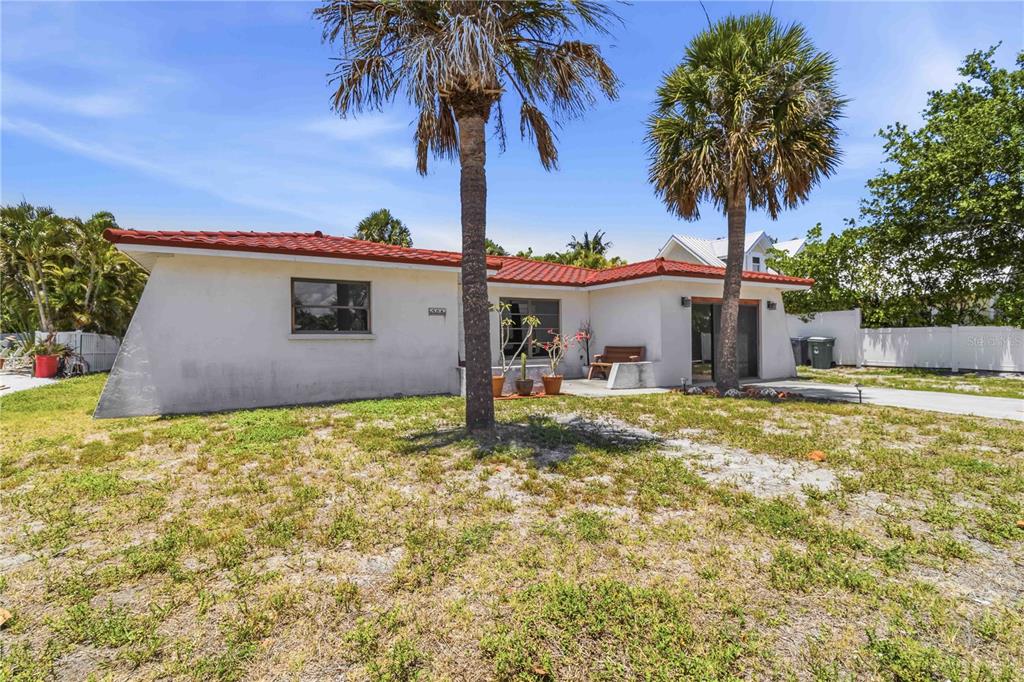A single-story house with a red tile roof and two palm trees in the yard — 306 PALM AVENUE, ANNA MARIA, FL