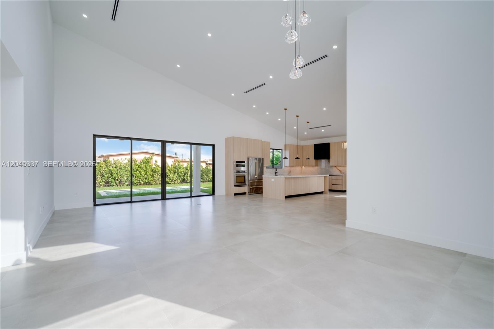 A modern, single-story house with a flat roof, white exterior walls, and a gray sports car — 4321 SW 99th Ave, Miami FL 33165, MIAMI, FL