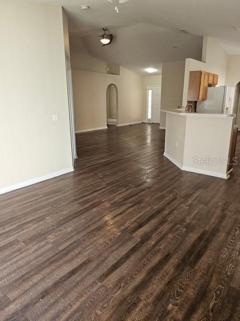 A view of an open-concept living area with wood-look flooring and a kitchen island — 10917 BANYAN WOOD WAY, RIVERVIEW, FL