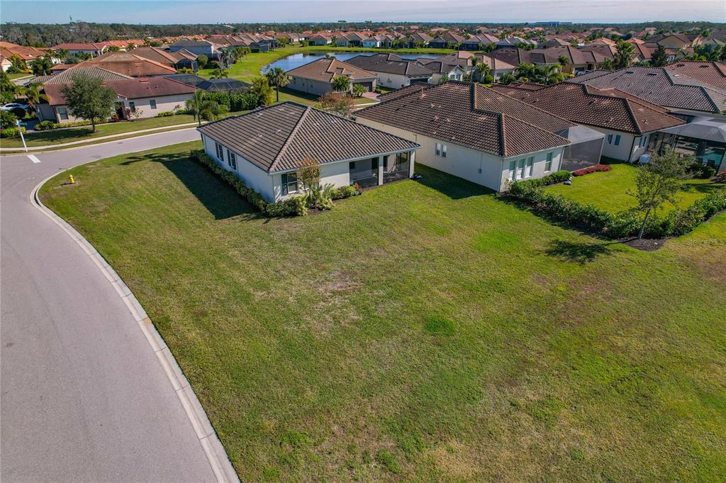 An aerial view shows a suburban house with a tiled roof and a large lawn — 4604 TOBERMORY WAY, BRADENTON, FL