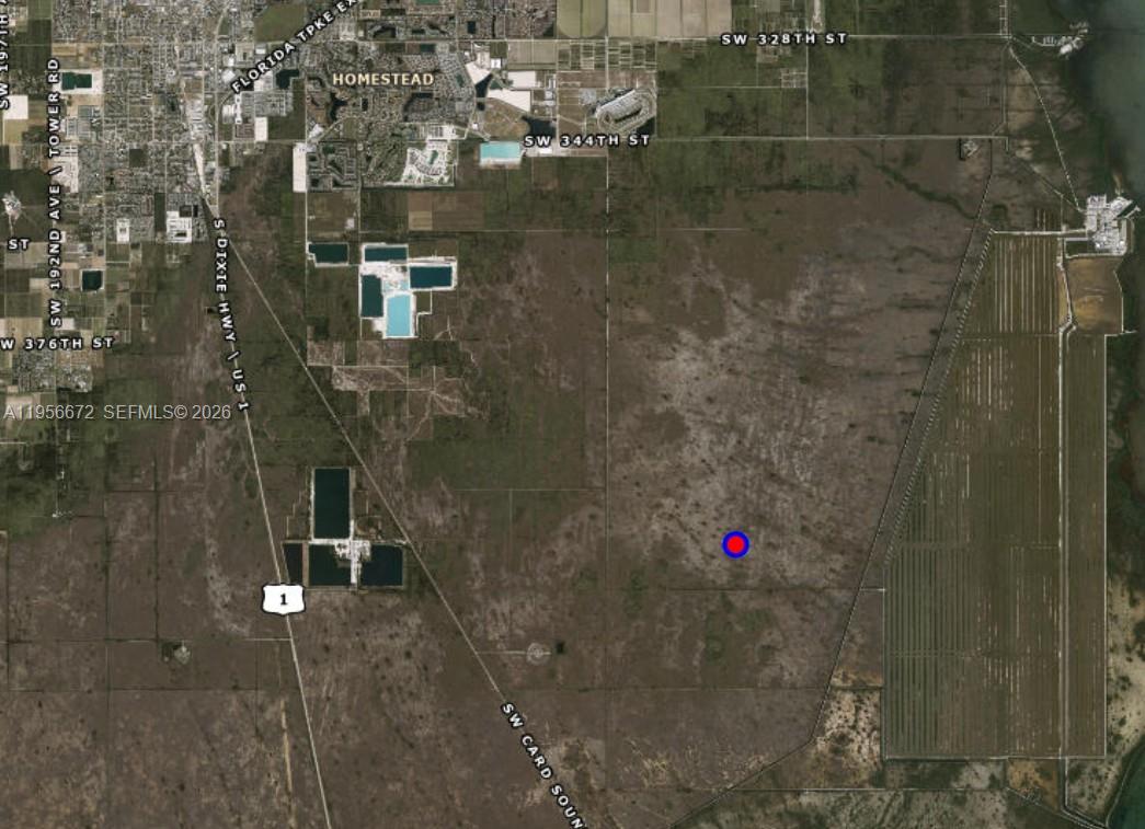This is an aerial map showing a plot of land marked with a blue dot — 0, Homestead FL 33035, HOMESTEAD, FL
