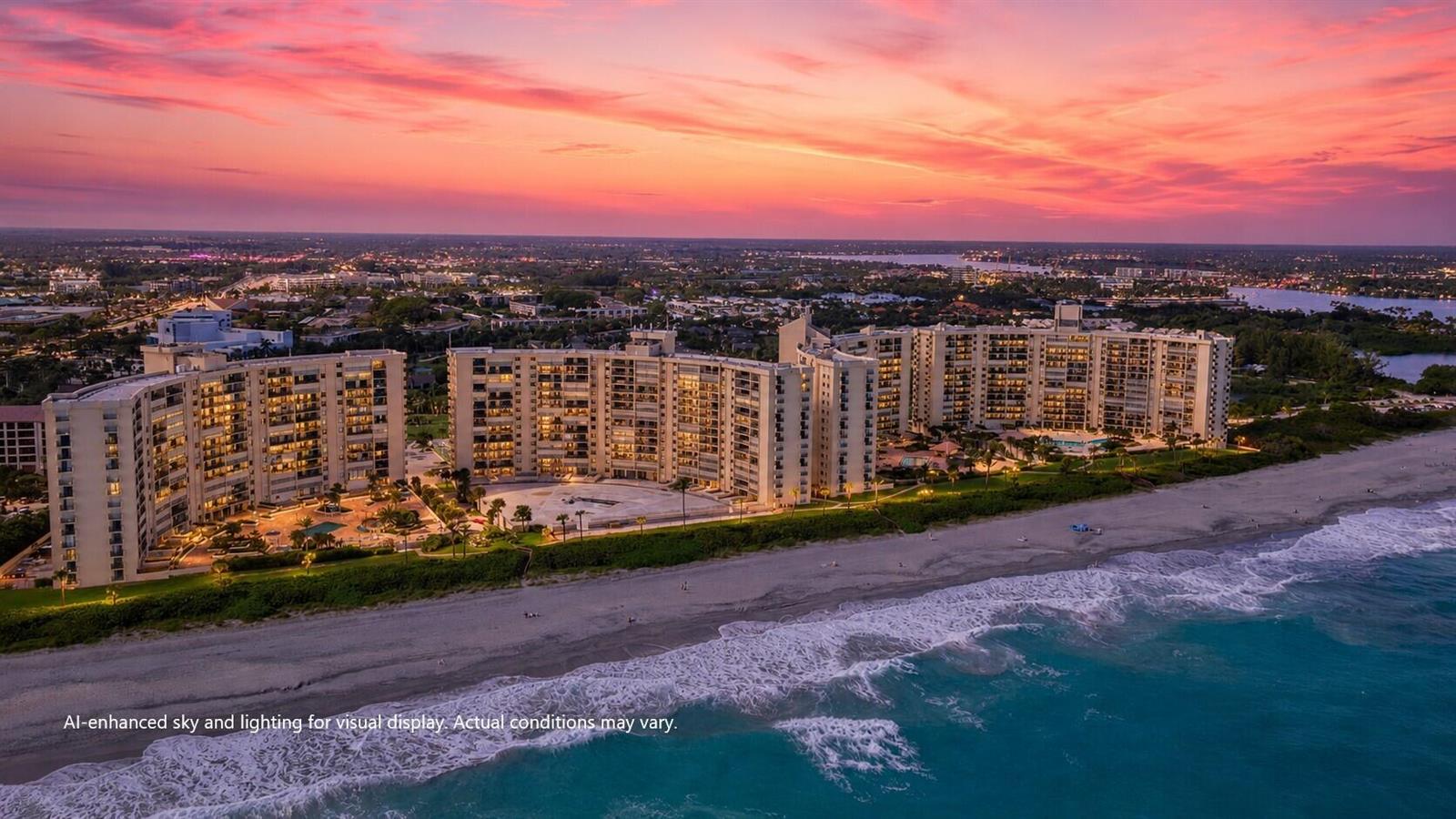 An aerial view of a large beachfront condominium complex at sunset with an enhanced sky — 400 Ocean Trail Way # 205, Jupiter FL 33477, JUPITER, FL