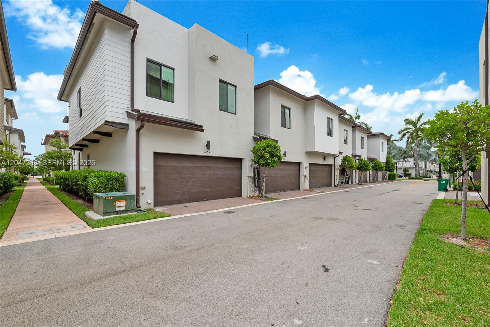 A row of modern two-story townhomes with brown garage doors and white stucco exteriors — 4605 NW 83rd Path, Doral FL 33166, DORAL, FL