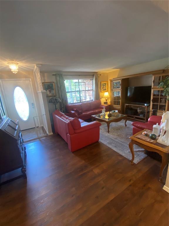 A living room features red leather sofas, wood flooring, and a large entertainment center — 1657 N NORMANDY BOULEVARD, DELTONA, FL