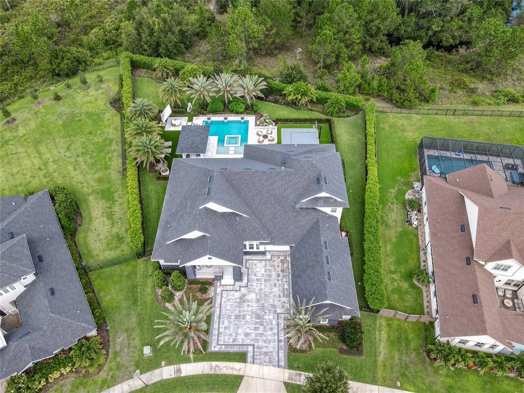 An aerial view shows a house with a pool, patio, and landscaped yard — 8600 HATA STREET, ORLANDO, FL