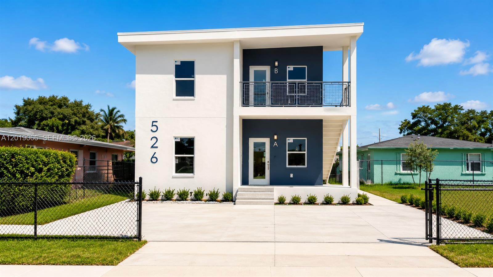 A modern two-story duplex with white and dark blue exterior walls and a concrete driveway — 526 NW 6th St, Hallandale Beach FL 33009, HALLANDALE BEACH, FL