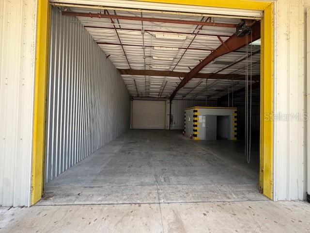An interior view of a large, empty industrial warehouse space with a concrete floor — 2251 TOPLINE WAY UNIT 5, BROOKSVILLE, FL