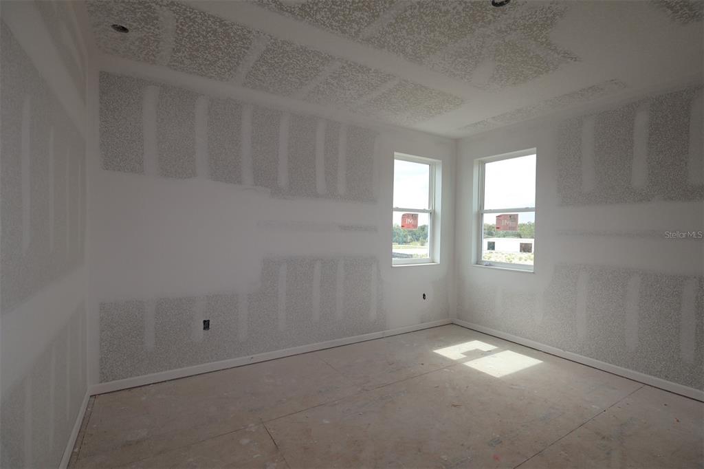 A single-story house with a two-car garage, stone-accented columns, and a covered front porch — 3206 WOLF LAKE AVENUE, APOPKA, FL