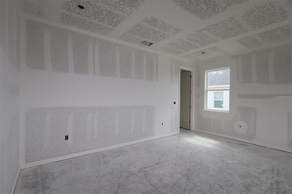 An open-concept kitchen and dining area features white cabinetry, a large island, and tile flooring — 3206 WOLF LAKE AVENUE, APOPKA, FL