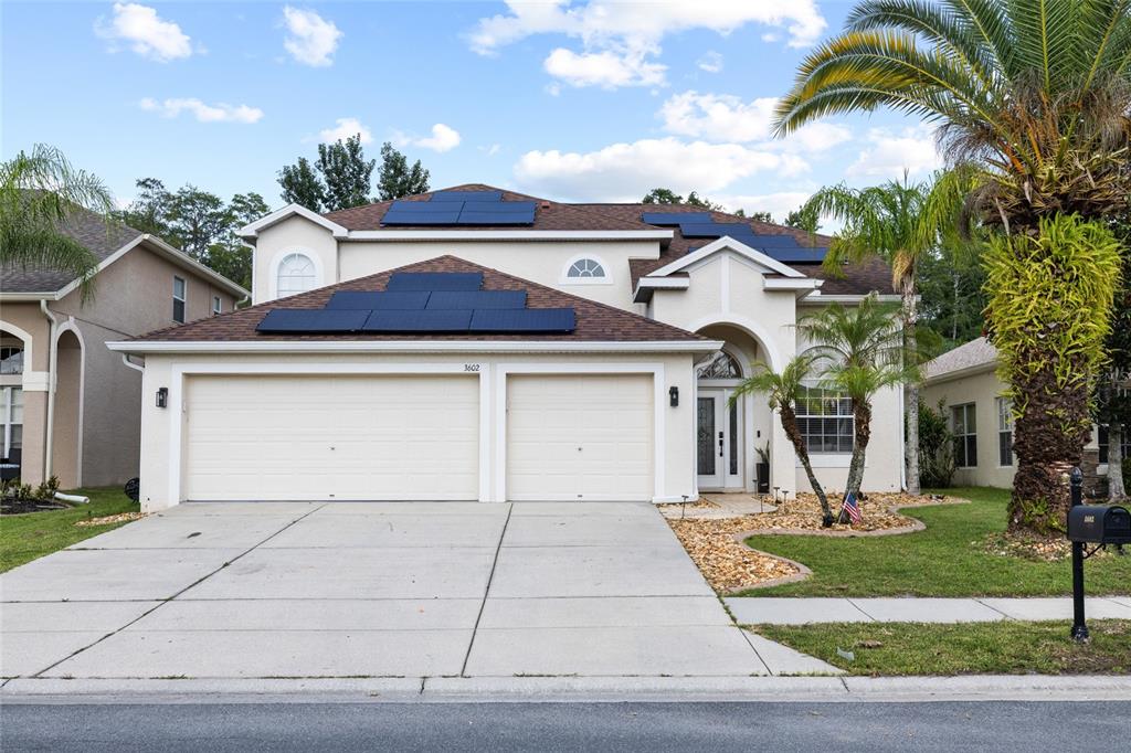 A two-story house with a two-car garage and solar panels on the roof — 3602 MORGANS BLUFF COURT, LAND O LAKES, FL