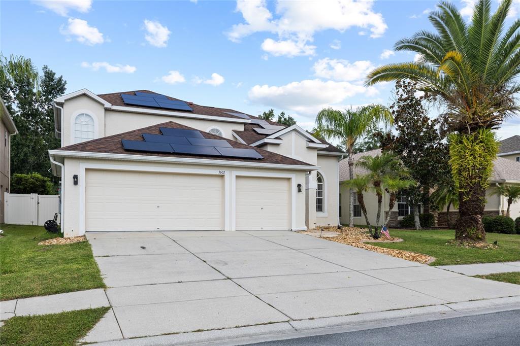 A two-story house with a two-car garage and solar panels on the roof — 3602 MORGANS BLUFF COURT, LAND O LAKES, FL