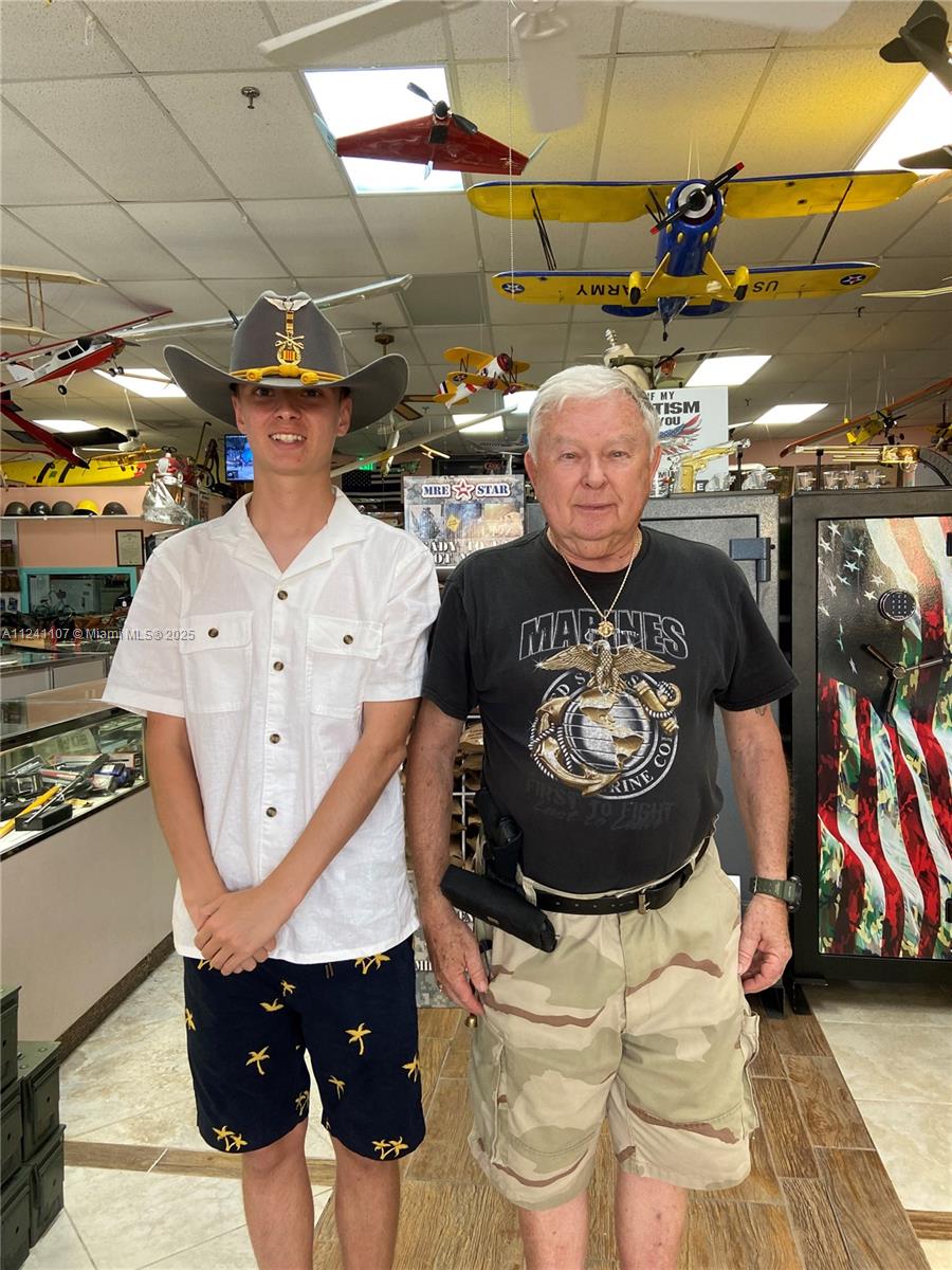 Two men stand in a retail store filled with model airplanes hanging from the ceiling — 755 NW Federal Hwy, Stuart FL 34997, STUART, FL