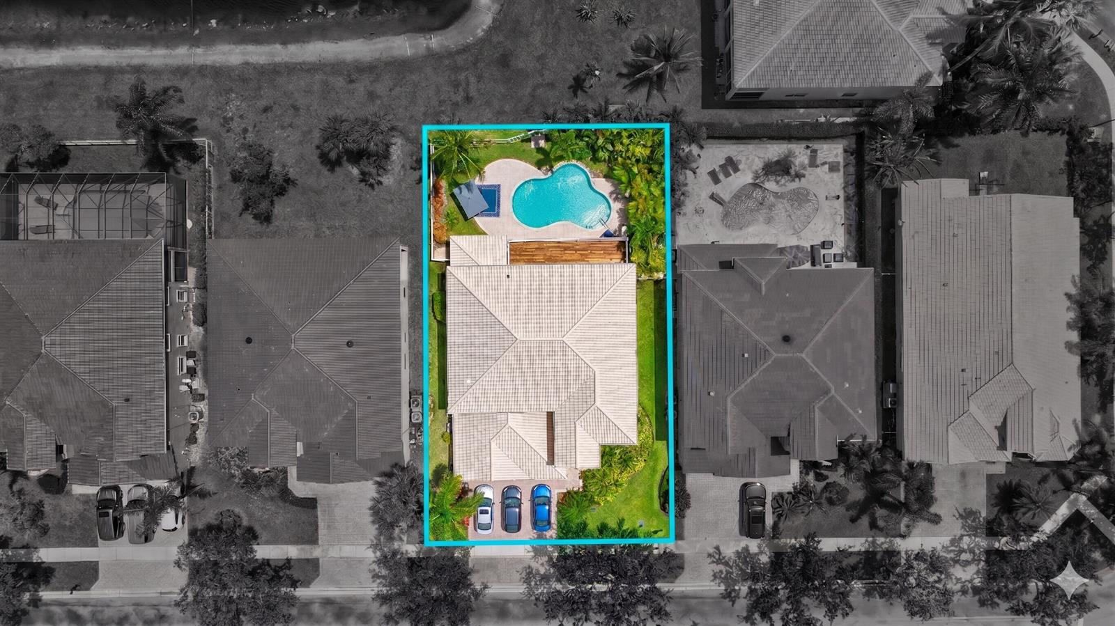 An aerial view of a residential property featuring a house, a swimming pool, and driveway — 11772 Bayou Lane, Boca Raton FL 33498, BOCA RATON, FL