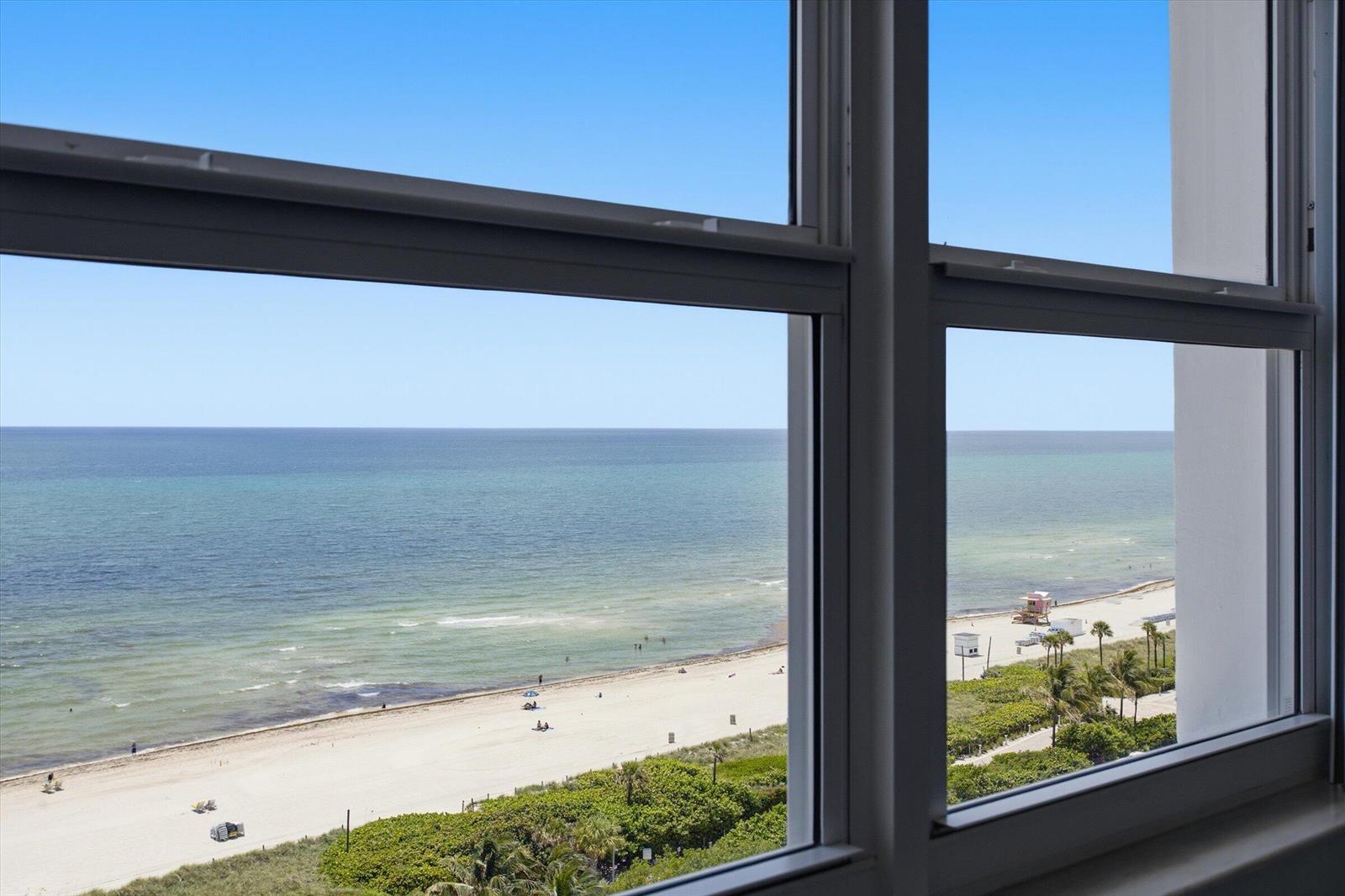 A view of a sandy beach and the ocean seen through a window — 4747 Collins Avenue # 1109, Miami Beach FL 33140, MIAMI BEACH, FL