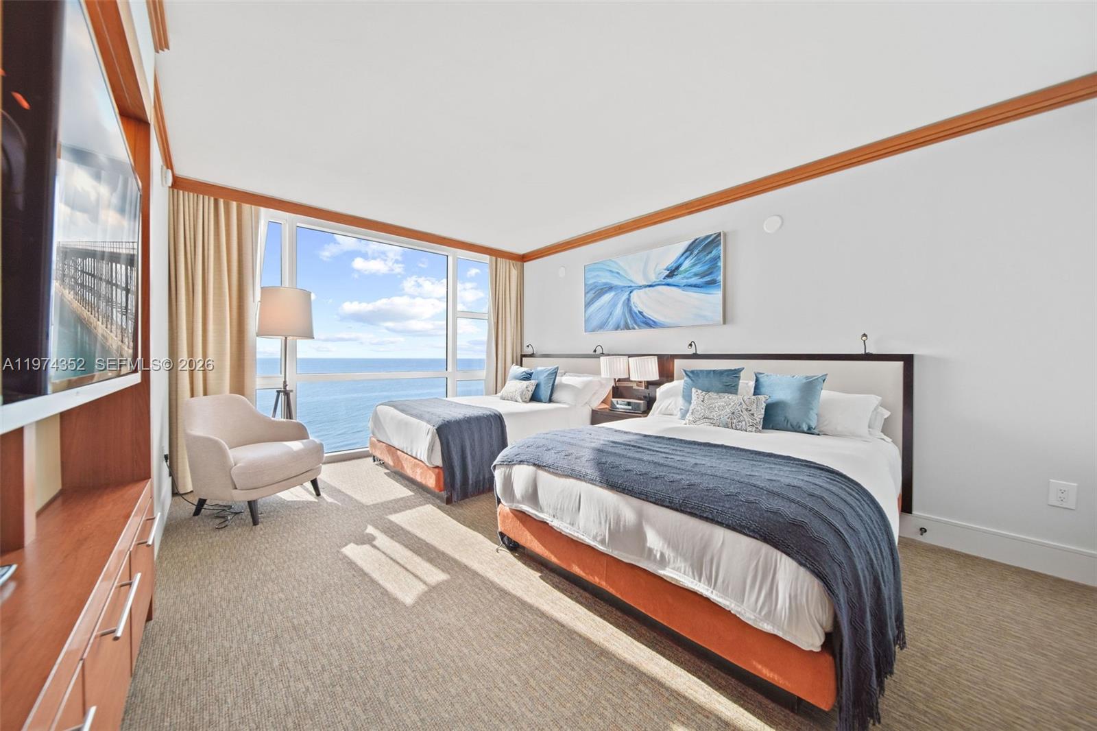 A hotel bedroom features two beds, a corner window with ocean views, and a television — 6801 Collins Ave # 604, Miami Beach FL 33141, MIAMI BEACH, FL
