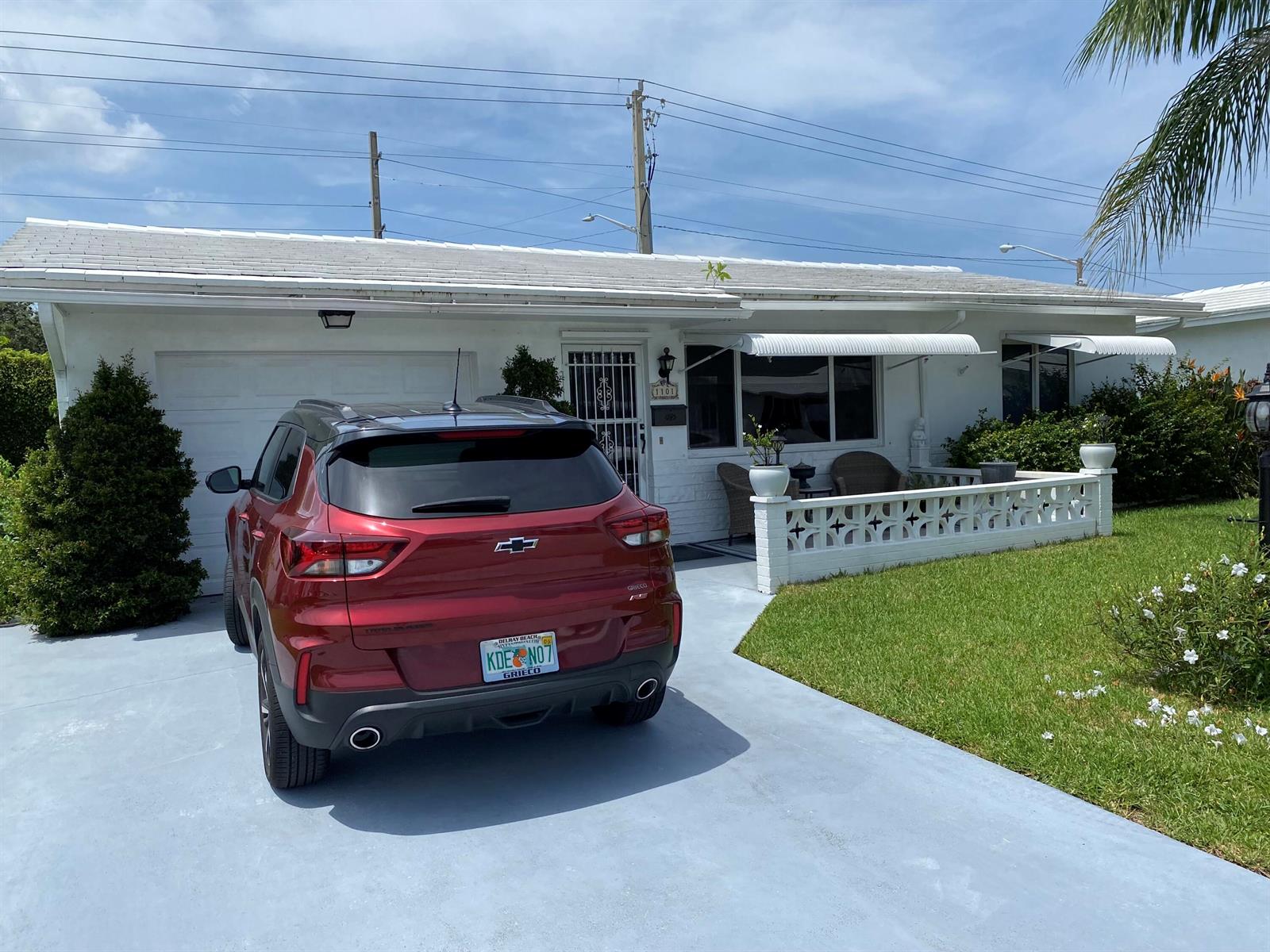 A red Chevrolet SUV is parked in the driveway of a white single-story house — 1101 Leisure Lane, Boynton Beach FL 33426, BOYNTON BEACH, FL