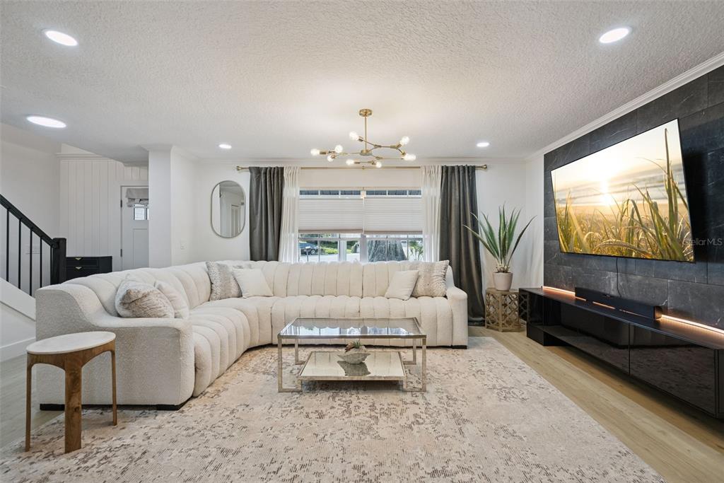 A living room features a large white sectional sofa, a glass coffee table, and a television — 3237 KEW GARDENS LANE, ORLANDO, FL