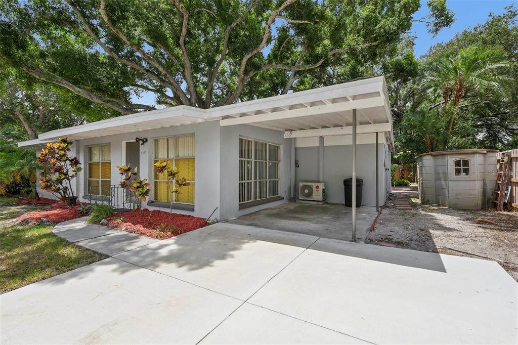 A single-story house with a gray exterior, a concrete driveway, and an attached carport — 2117 BARCELONA DRIVE, CLEARWATER, FL