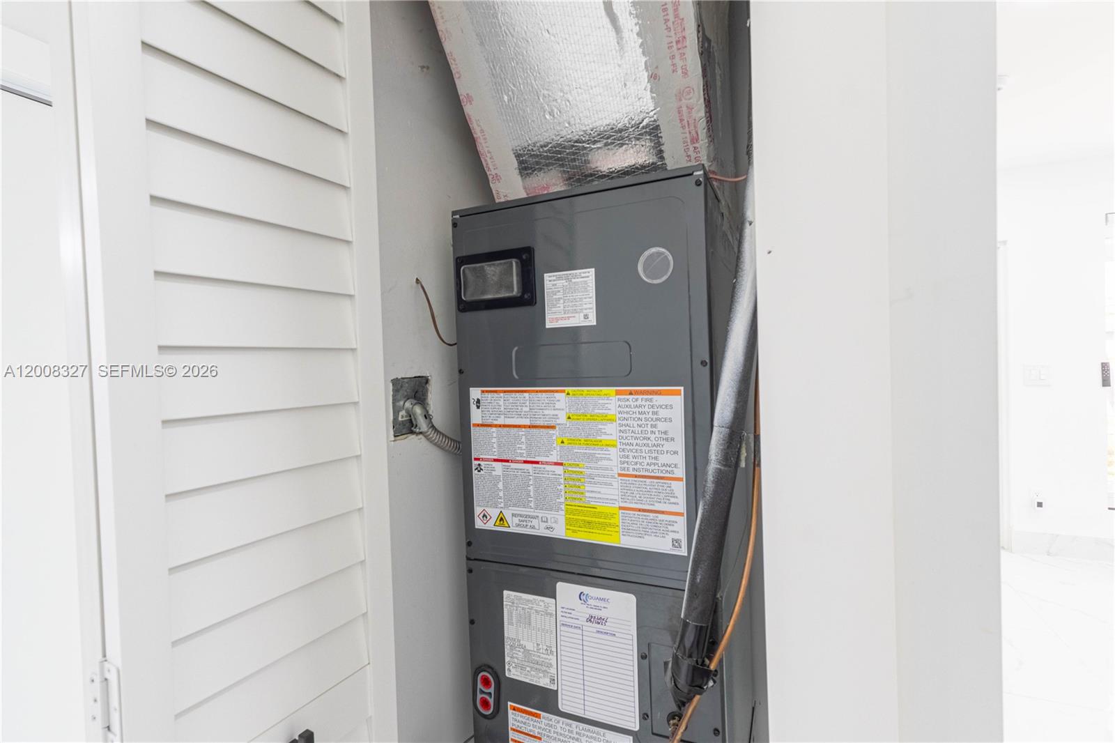 A gray HVAC air handler unit is installed inside a small utility closet — 3001 SW 35th Ave, West Park FL 33023, WEST PARK, FL
