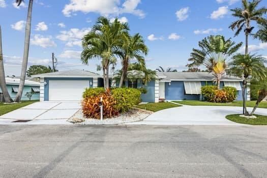 A blue single-story house with a white garage and palm trees in the front yard — 3101 Pierson Drive, Delray Beach FL 33483, DELRAY BEACH, FL