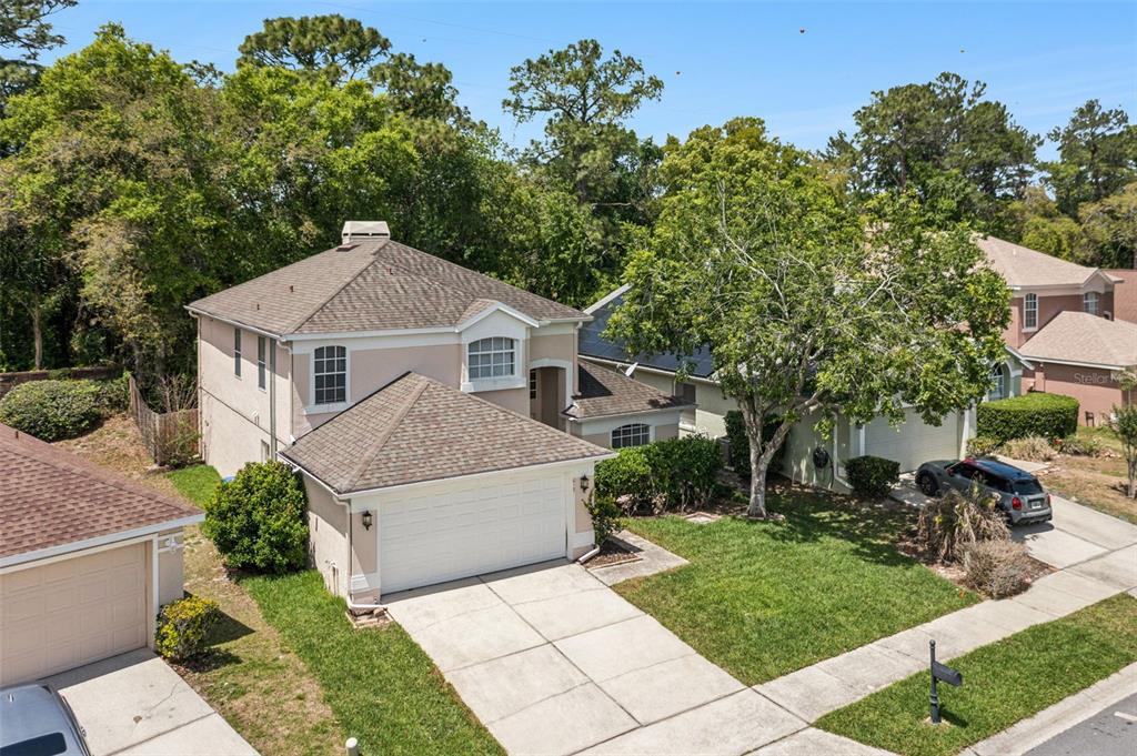 An aerial view of a two-story suburban house with a tan exterior and garage — 617 RANDON TERRACE, LAKE MARY, FL