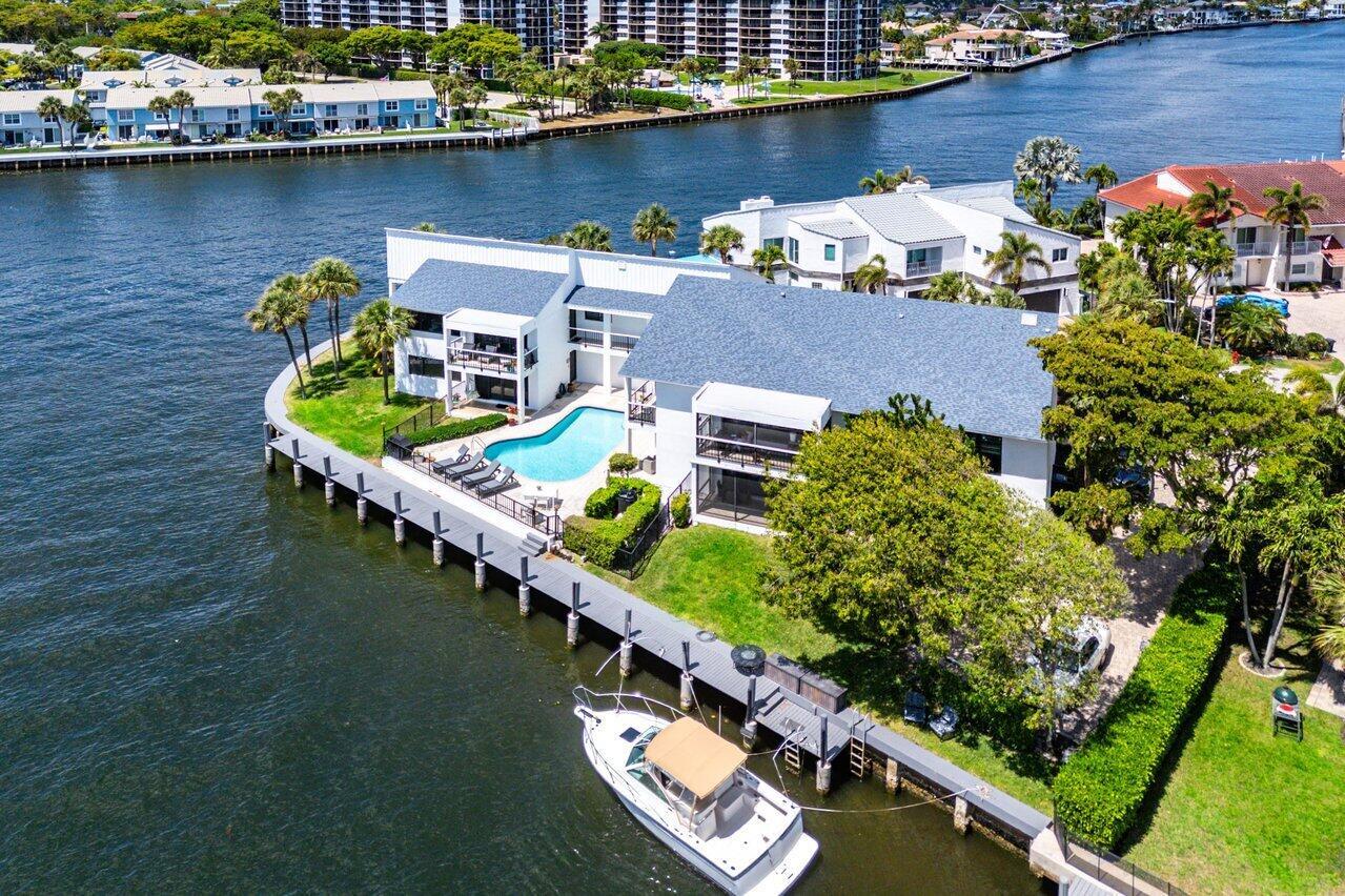 An aerial view of a waterfront house with a swimming pool and a docked boat — 1102 Highland Beach Drive # 2w, Highland Beach FL 33487, HIGHLAND BEACH, FL