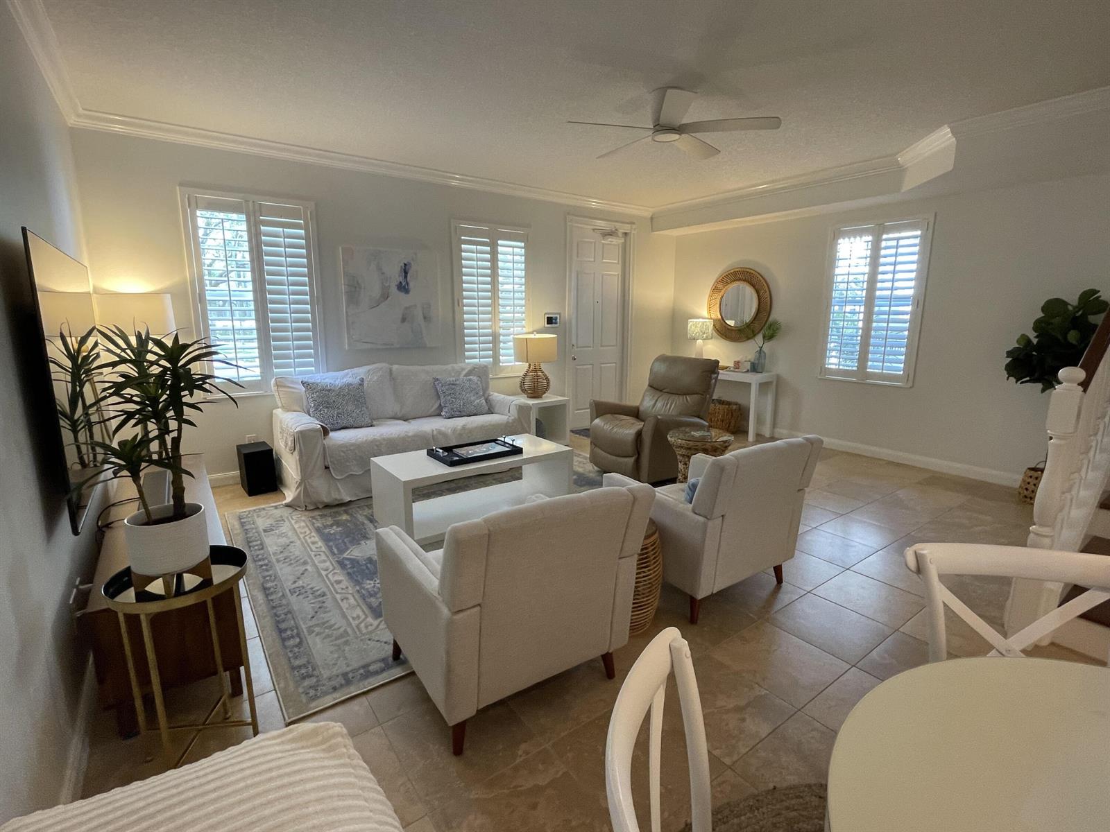 A living room with tile floors, a white sofa, two armchairs, and a recliner — 2857 E Community Drive, Jupiter FL 33458, JUPITER, FL