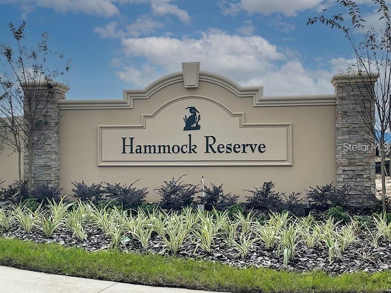 A beige monument sign with a bird logo reads Hammock Reserve in front of landscaping — 3886 WHITNEY WAY, HAINES CITY, FL
