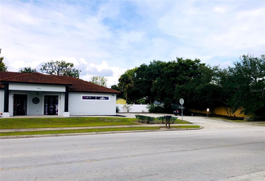 A single-story commercial building with a tiled roof and a paved parking lot — 3001 MICHIGAN AVENUE UNIT B, KISSIMMEE, FL