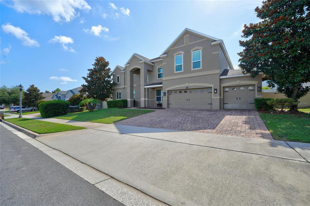 A two-story suburban house with a three-car garage and a paved driveway — 16004 OLLIVETT STREET, WINTER GARDEN, FL