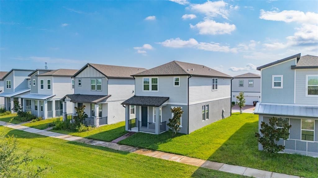 A row of modern two-story suburban houses with light gray siding and dark shingled roofs — 4629 CROSS PRAIRIE PARKWAY, ST CLOUD, FL