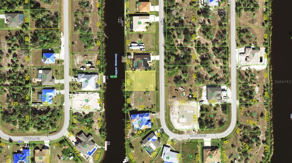 This is an aerial map showing residential lots and a waterway in a neighborhood — 9620 PRESIDENT CIRCLE, PORT CHARLOTTE, FL